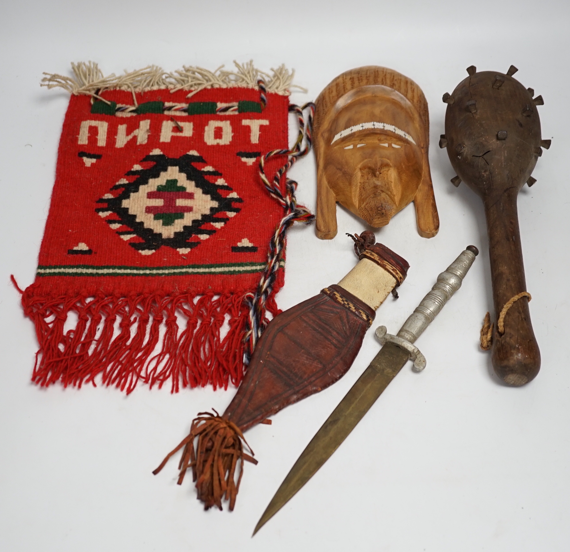 A kukri, a long dagger and sheath, a mace, and two African ebony busts